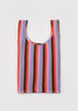 Multicolored striped tank top on a light gray background