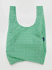 a green gingham reusable baggu bag on a white background