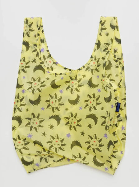 a yellow with green stars and suns patterned reusable baggu bag on a white background