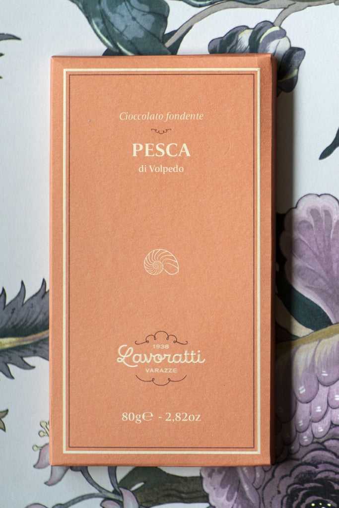 A box of Cioccolato Lavoratti Peach Dark Chocolate Bar sits in front of a floral background. 