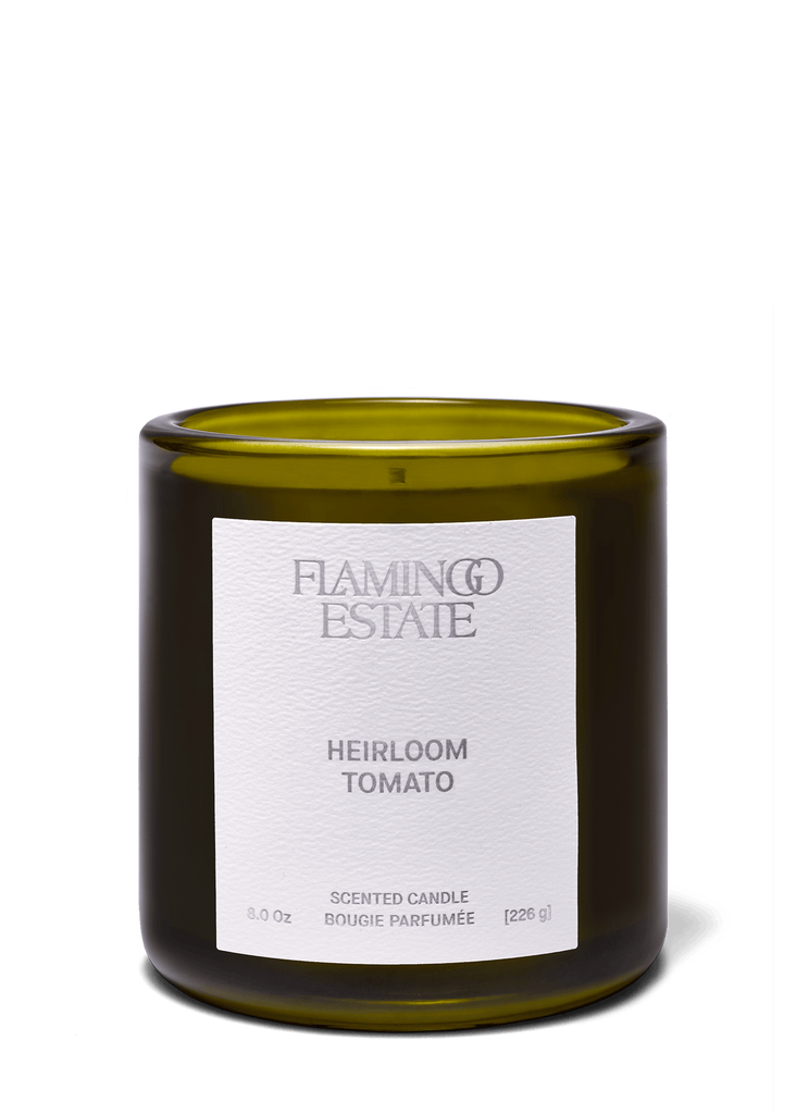 Candle with 'Flamingo Estate' label on a green background