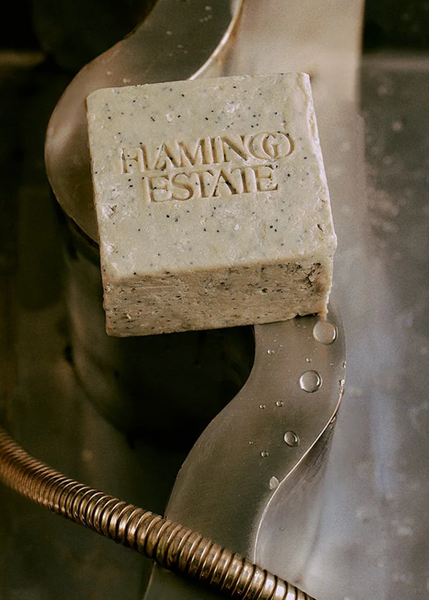 Bar of soap with 'Flaming Estate' branding on a metallic surface