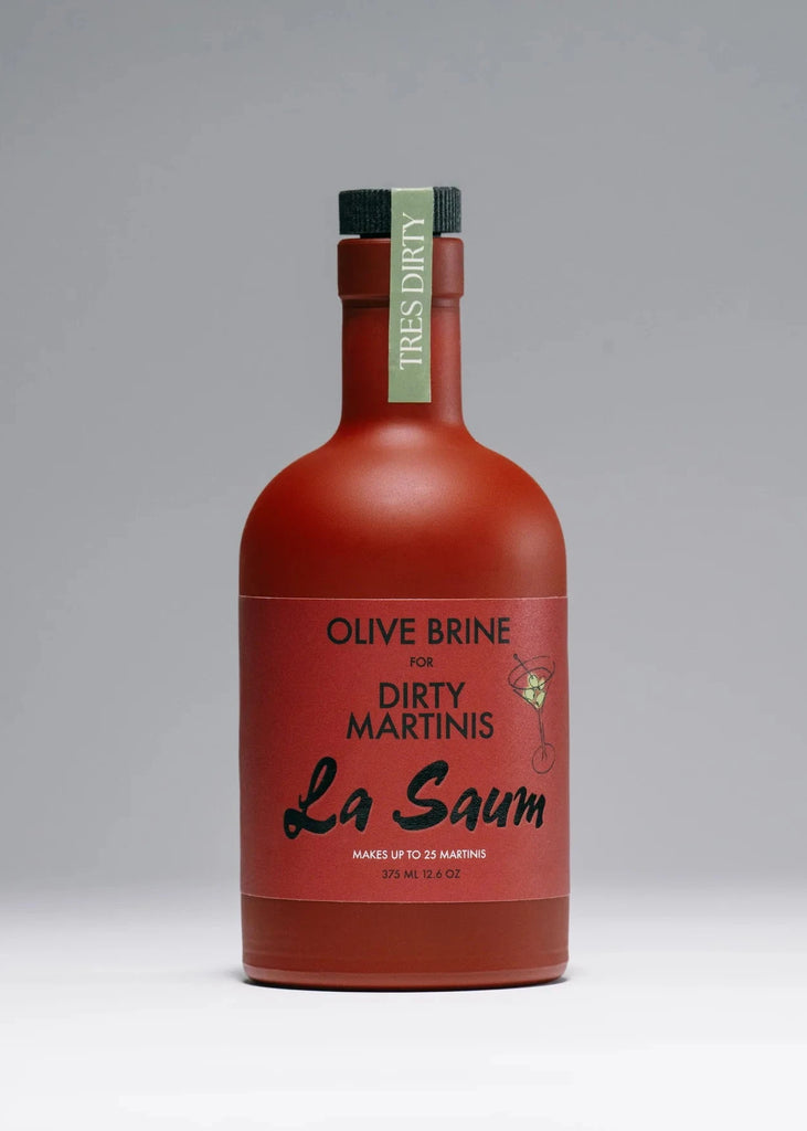 Red bottle of Olive Brine for Dirty Martinis on a gray background