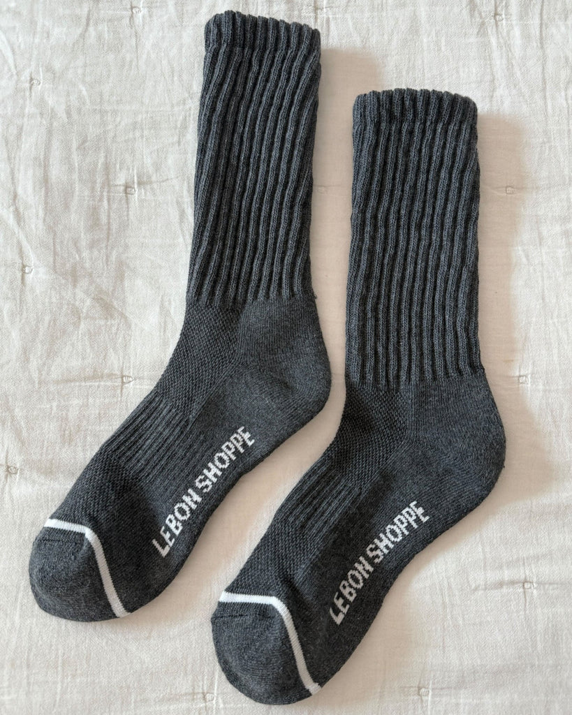 Pair of Charcoal socks with 'Le Bon Shoppe' branding on a textured surface