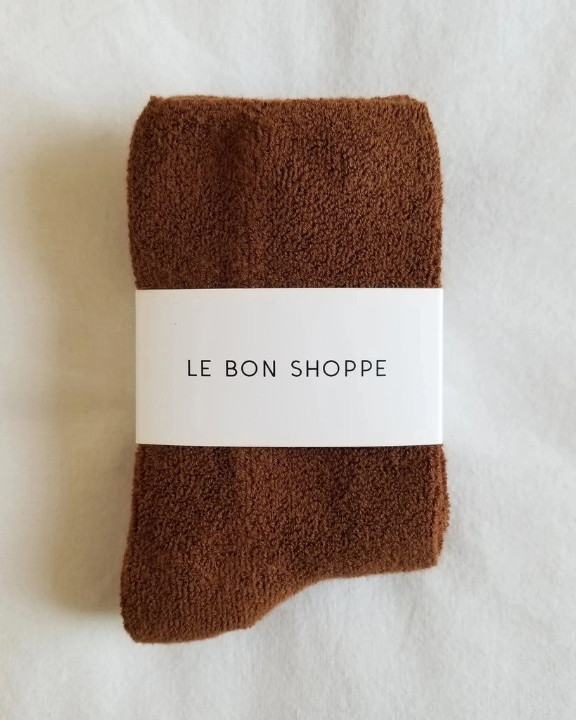 Folded Sepia socks with a white label reading 'Le Bon Shoppe' on a light background