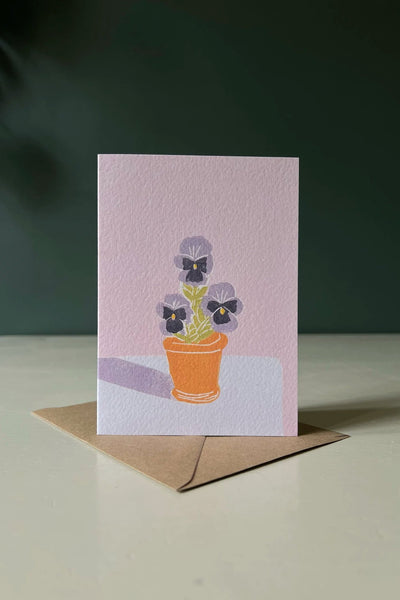 A greeting card depicting pansies in a small terracotta pot from Luiza Holub.