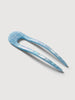 a light blue shell French hair pin by machete sitting on a white background.