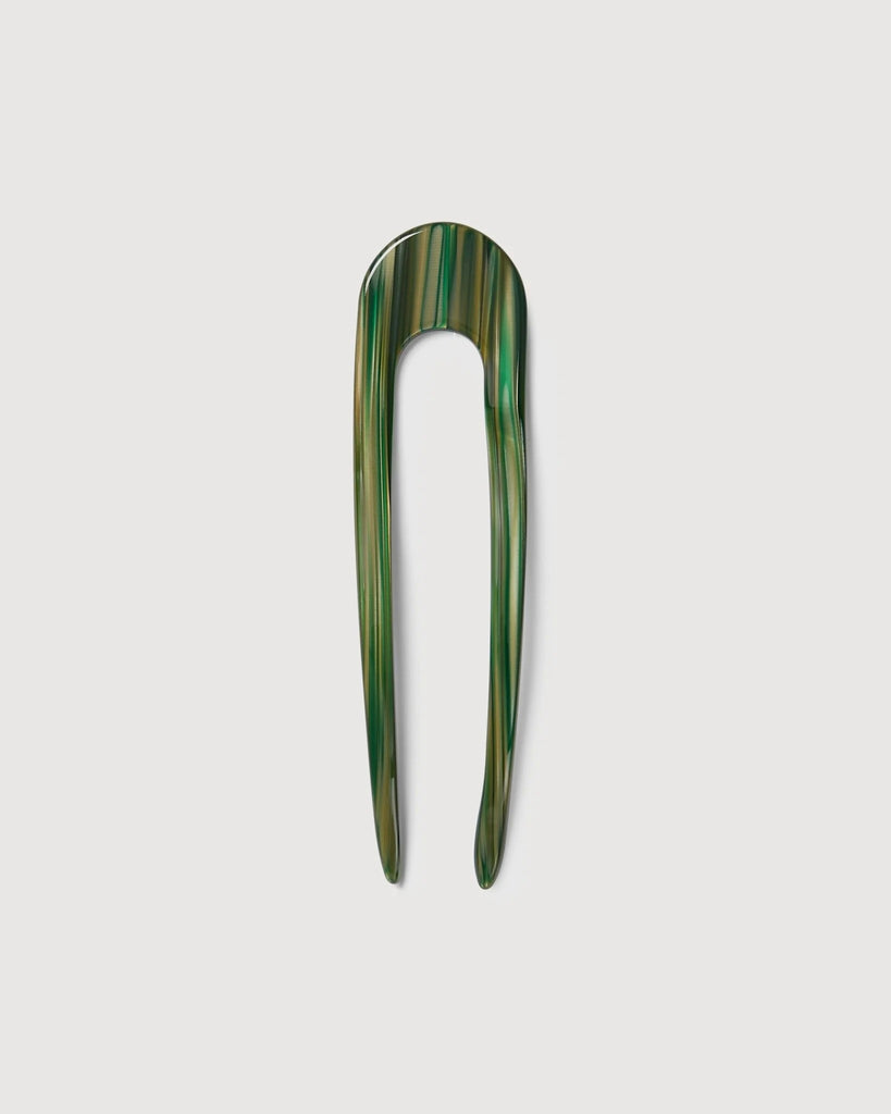 a meadow green French hair pin by machete sitting on a white background.