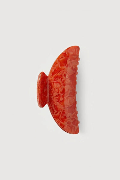 a poppy red midi heirloom claw hair clip by machete sits on a white background.