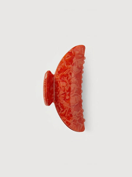 a poppy red midi heirloom claw hair clip by machete sits on a white background.