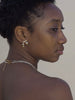 a woman wearing 14k gold filled post earrings with asymmetrical beads inspired by Asian lanterns, made by Marida jewelry