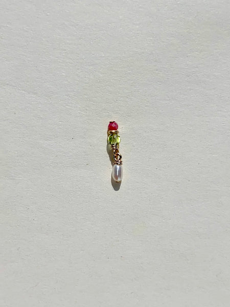a single little earring with faceted pink opal peridot and a seed pearl from Marida jewelry in Long Beach California