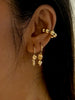 a woman with dark hair wears 14k gold filled hugging hoop earrings with asymmetrical beads inspired by roman pillars, made by Marida jewelry