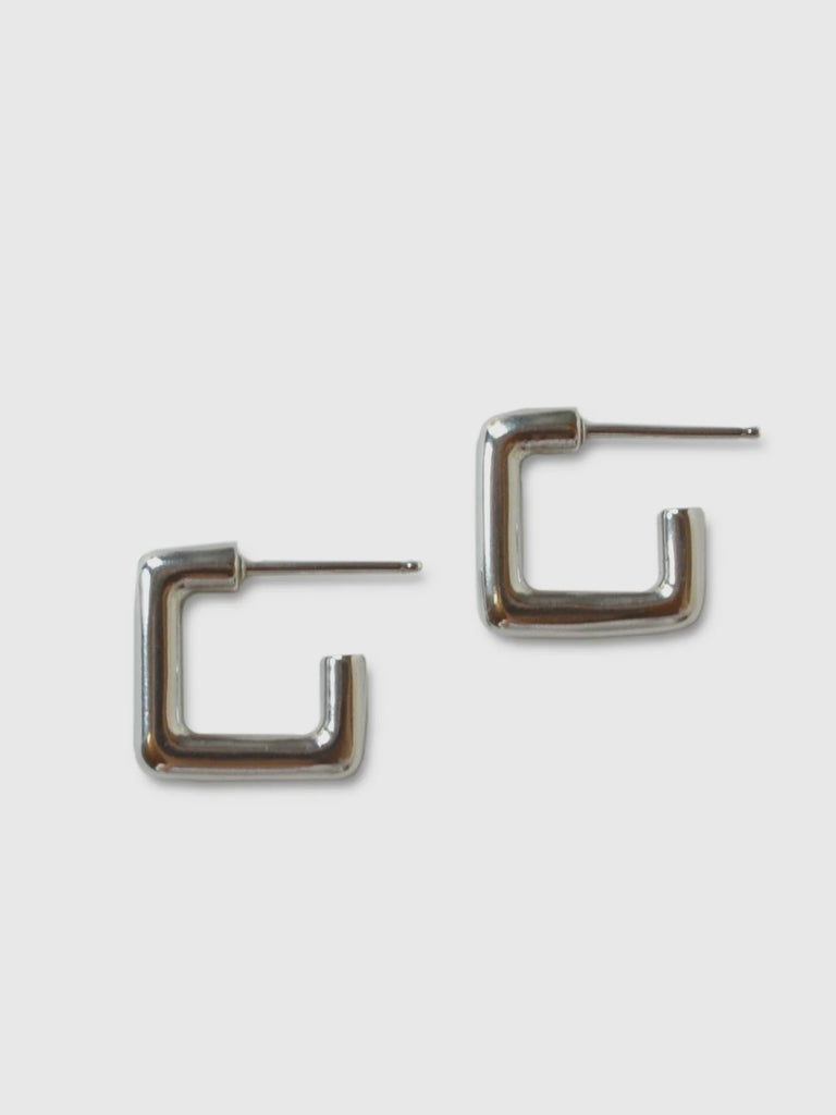 a pair of small square sterling silver hoops on a white background - made by Natalie joy jewelry
