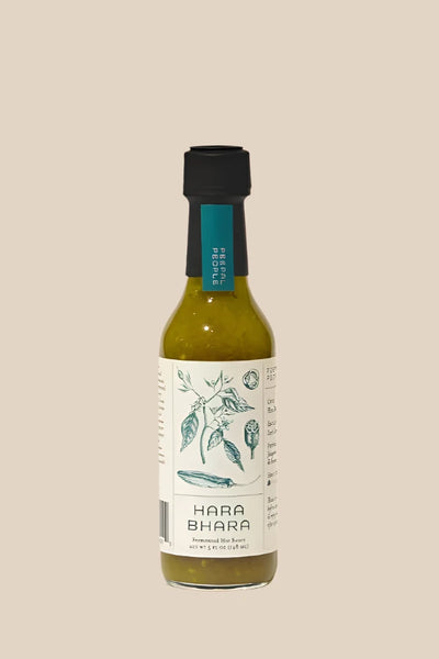 a bottle of peepal people's Hara bhara hot sauce on a creamy beige background