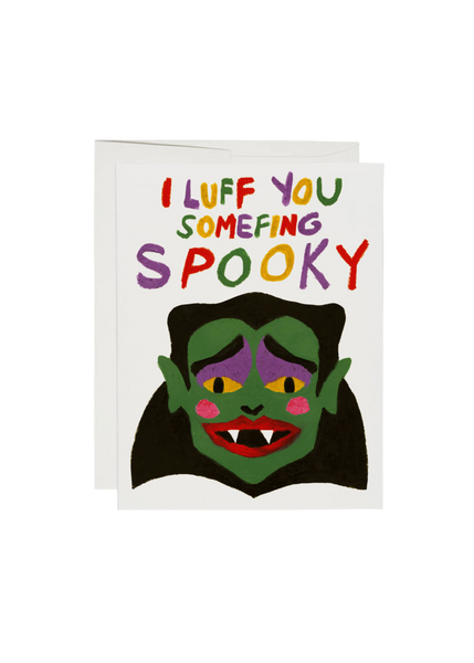 Greeting card with a cartoon vampire face and colorful text on a white background