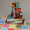 a pack of colorful playing cards arranged in a playful pyramid on a table.