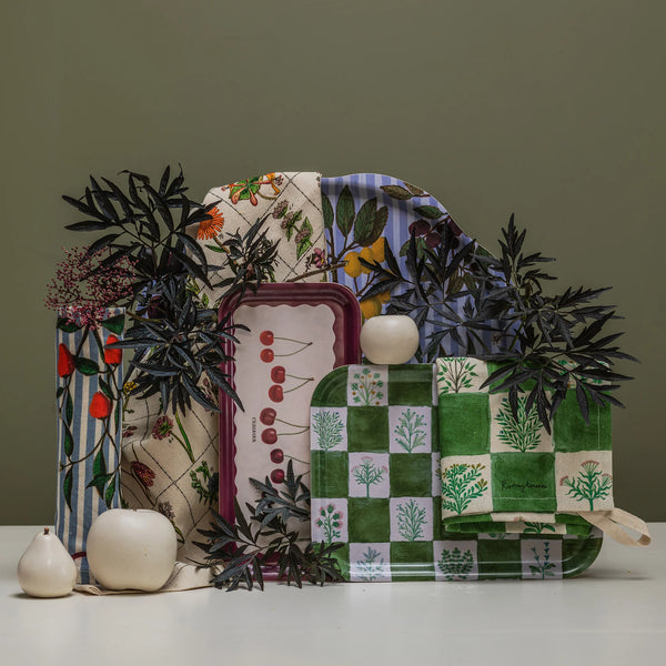 a collection of trays sit on a table with a green background.