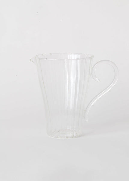 Clear glass pitcher on a white background
