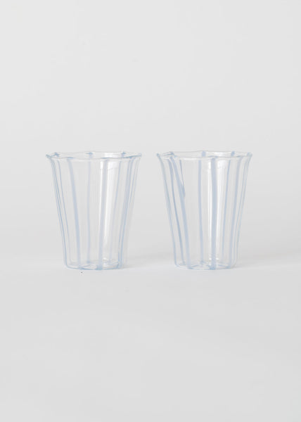 Two clear glasses with blue stripes  on a white background