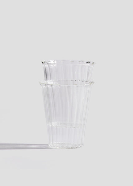 Clear glass vase on a light gray background