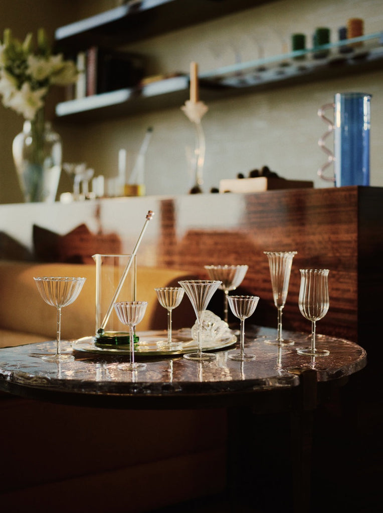 clear bar glass collection by Sophie Lou Jacobsen styled on a marble table inside a bar