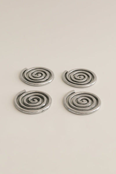 four silver spiral metal coasters 