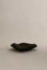 Sophie Lou Jacobsen's pecan brown colored glass plate with a petal shaped wavy rim sits on a white background