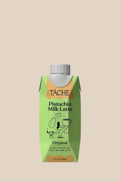 A carton of Táche pistachio milk latte sits on a white background.