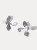 Sterling silver four petal flower shaped earrings made by cled against a white background 