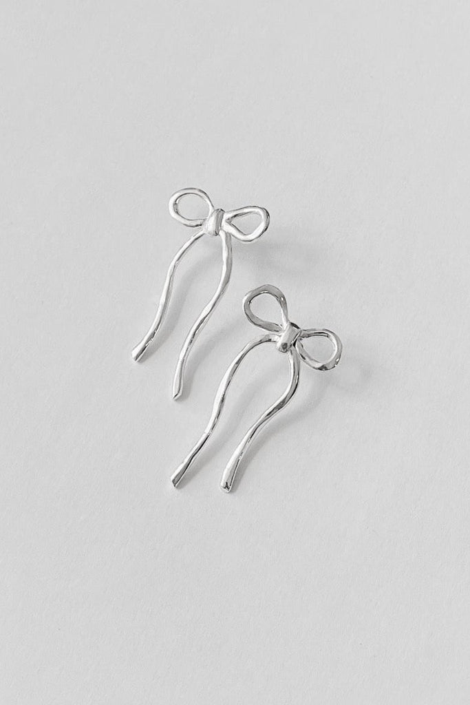 silver earrings shaped like bows by Kara Yoo against a white background 