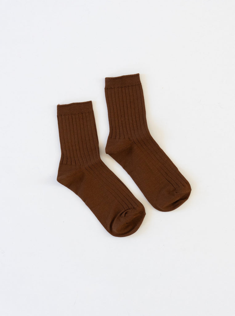 A dijon brown pair of ribbed le bon shoppe her socks against a white background 