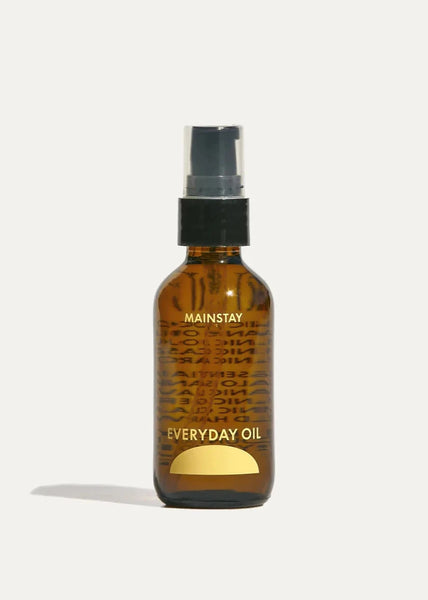 A brown amber bottle with a black pump labeled 'EVERYDAY OIL MAINSTAY'.